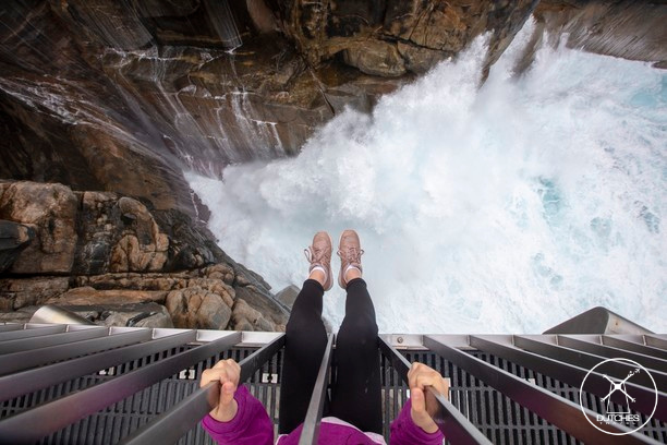 Voeten bungelen boven water van The Gap